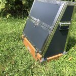 Dark gray metal tack trunk outdoors.