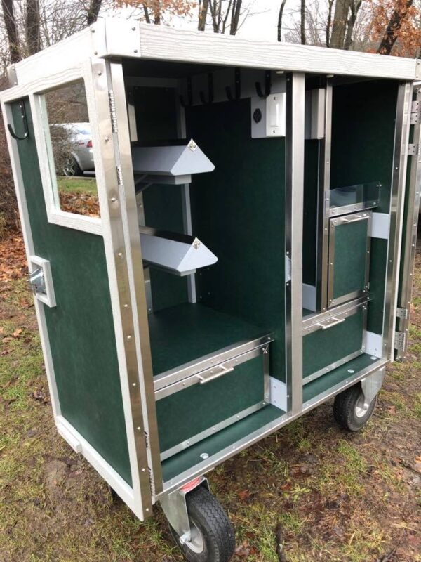 Green mobile grooming cart with shelves.