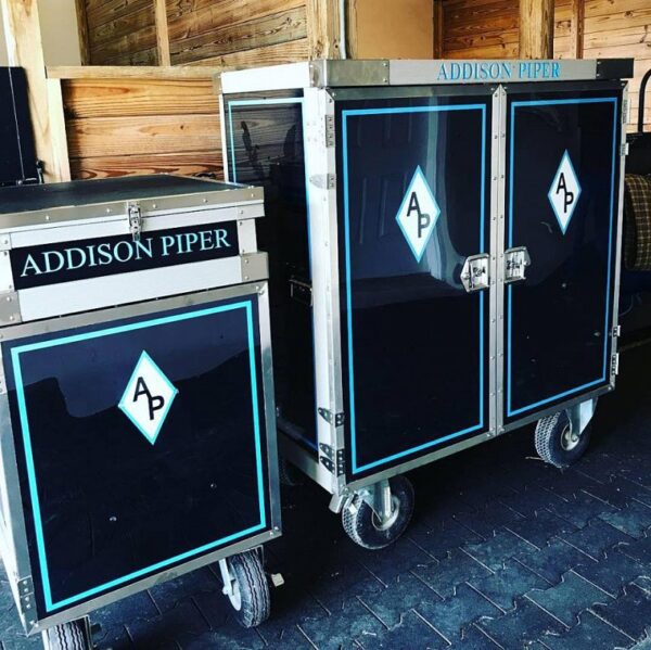 Addison Piper tack trunks with logo.
