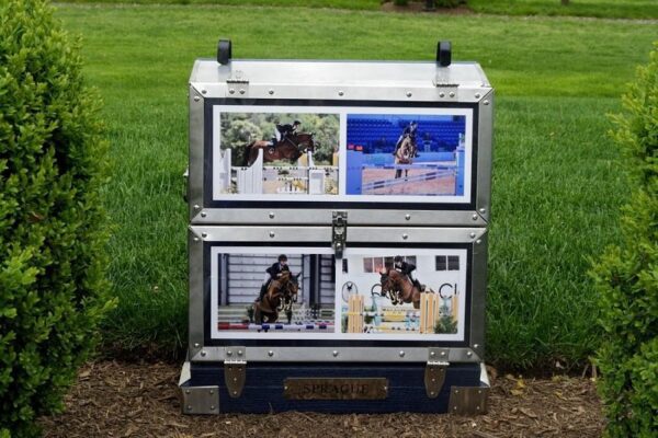 Here's an alt tag for the image: > Show jumping photos in metal trunk.