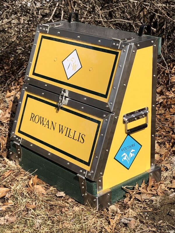 Here's an 8-word alt tag for the image: Yellow Rowan Willis Voltaire Design horse tack trunk.