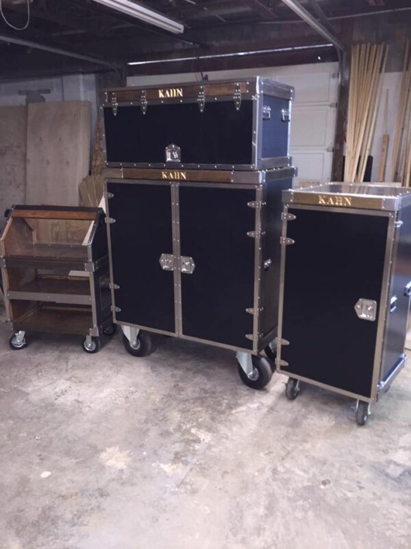 Black metal rolling trunks and cart.