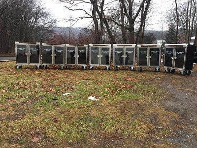 Row of catering carts outdoors.