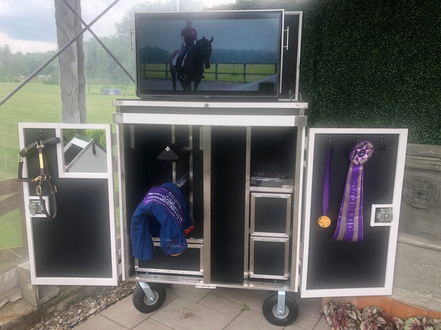 Mobile tack trunk with TV, showing ribbons.