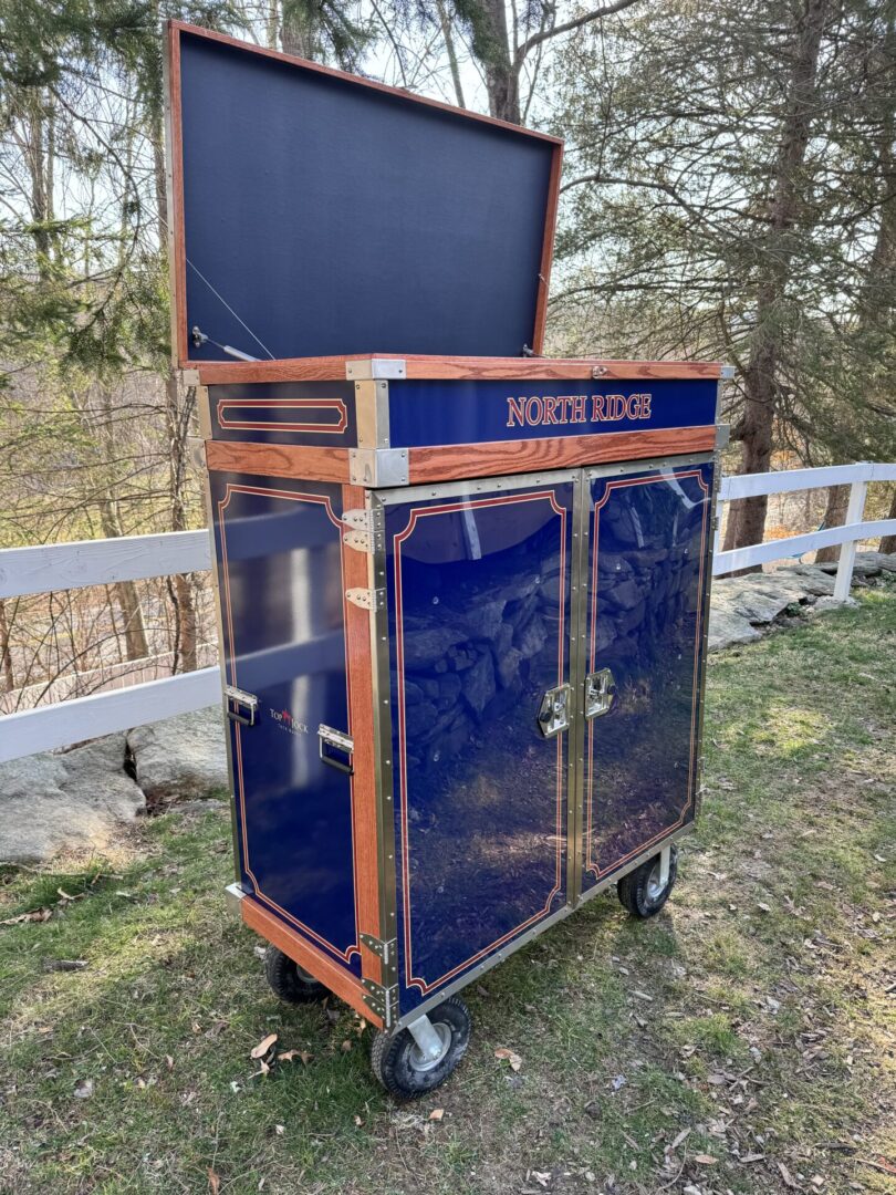 A blue and orange cart with two doors open.