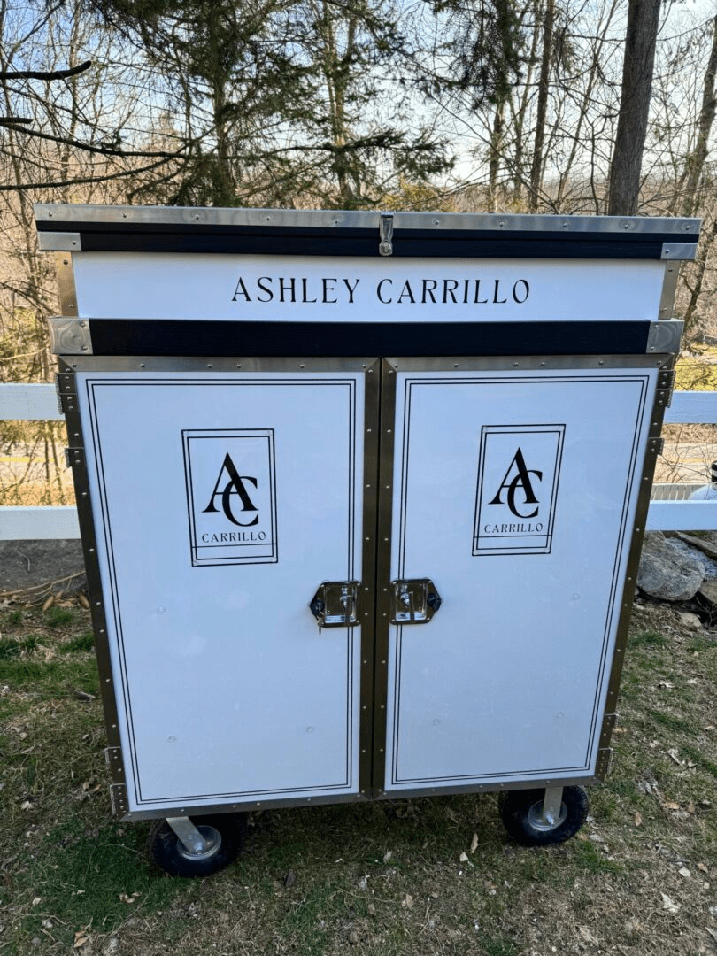 Custom white wooden cabinet with Ashley Carrillo branding.