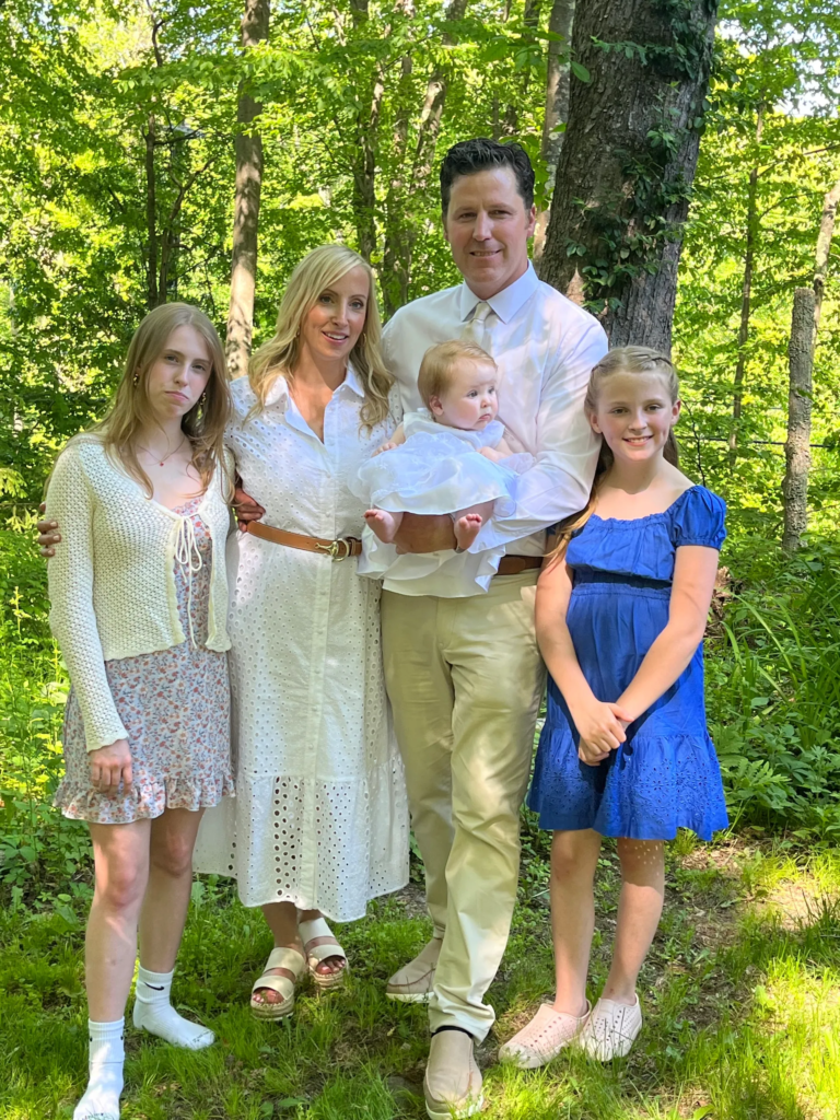 blob (4) A family posing for a picture in the woods.