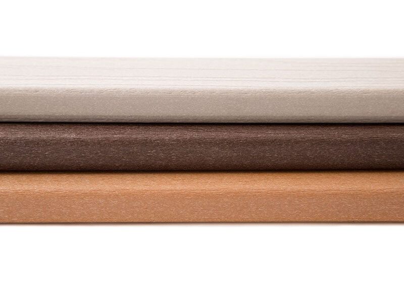 Three composite decking samples, stacked.