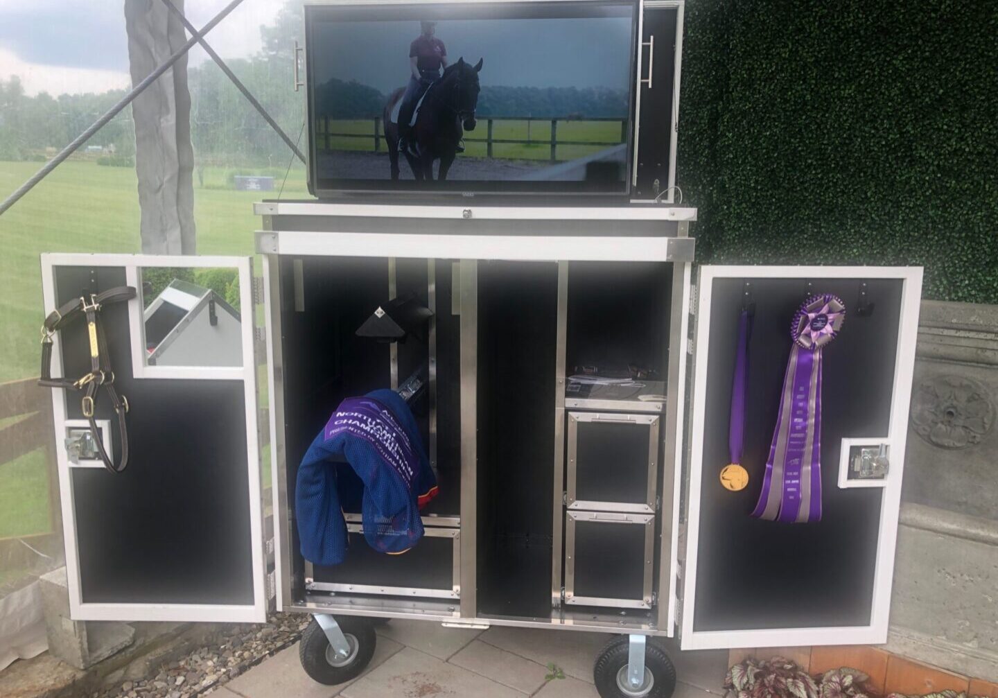 Mobile tack trunk with TV, showing ribbons.